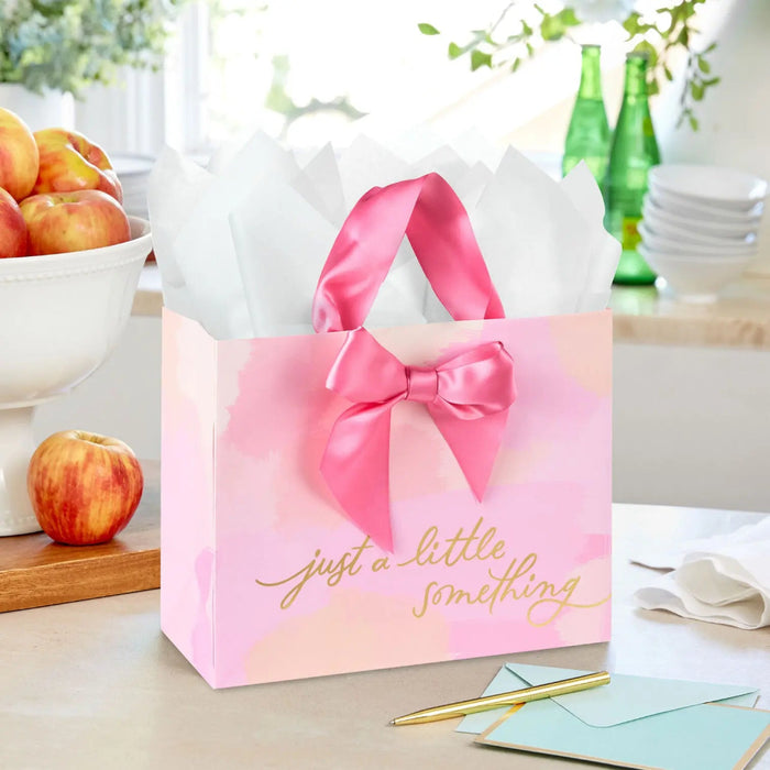 Watercolor‑style pink gift bag with gold‑foil lettering styled on a tabletop with a matching card for birthdays or Mother’s Day