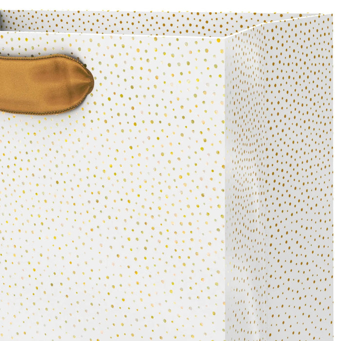 Close‑up of cream gift bag with gold dots