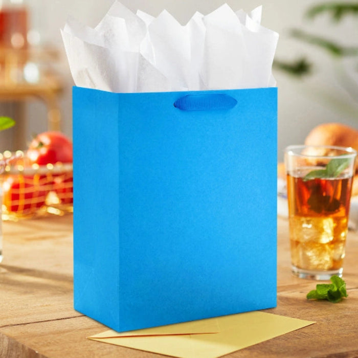 Hallmark 9.6-inch solid royal blue medium gift bag with a vibrant matte finish, sturdy carrying handles, and a classic design for birthdays, holidays, graduations, and special occasions.