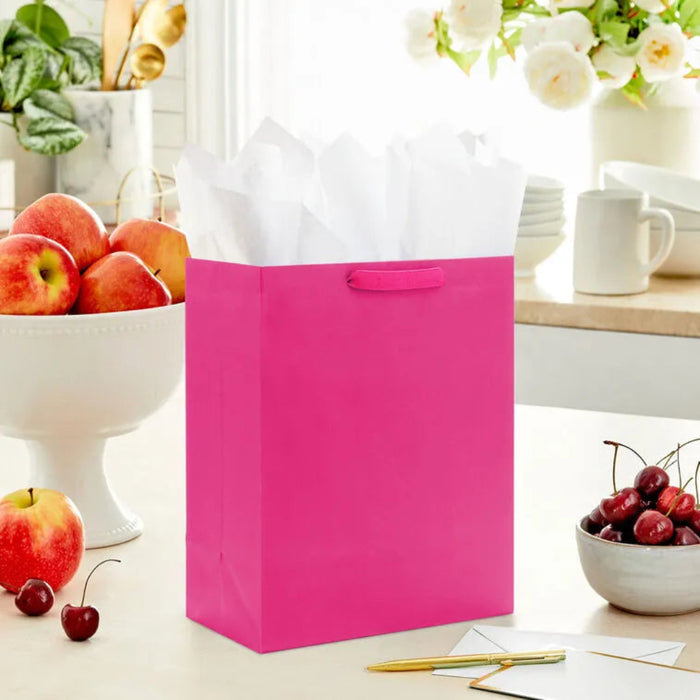 Hallmark 13-inch large hot pink gift bag for birthdays, celebrations, holidays, and special occasions.