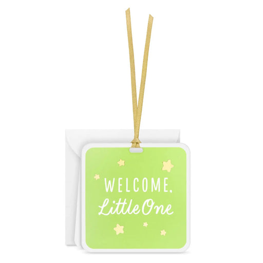 Square folded gift tag with “Welcome Little One” message on green, gold foil stars, and gold ribbon hanger