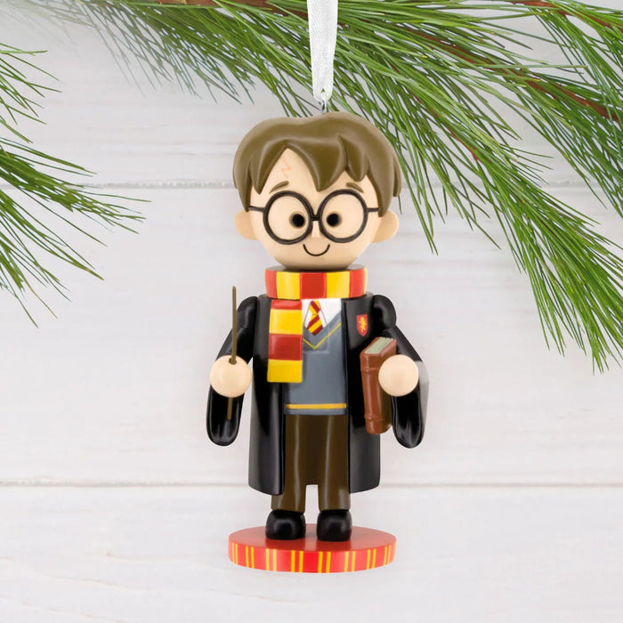 Hallmark Harry Potter™ nutcracker Christmas ornament featuring Harry in Gryffindor robes and scarf, holding his wand, with a hanger attachment.