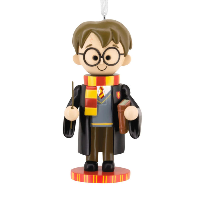 Hallmark Harry Potter™ nutcracker Christmas ornament featuring Harry in Gryffindor robes and scarf, holding his wand, with a hanger attachment.