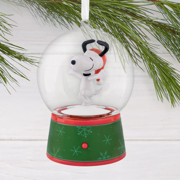 Hallmark Peanuts Snoopy musical snow globe Christmas ornament with swirling snow, festive holiday music, motion, and hanger attachment.