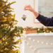 This Hallmark Minions Bob in Santa Hat Hallmark Ornament adds playful holiday cheer to your Christmas décor with one of the most lovable characters from the Minions movies.