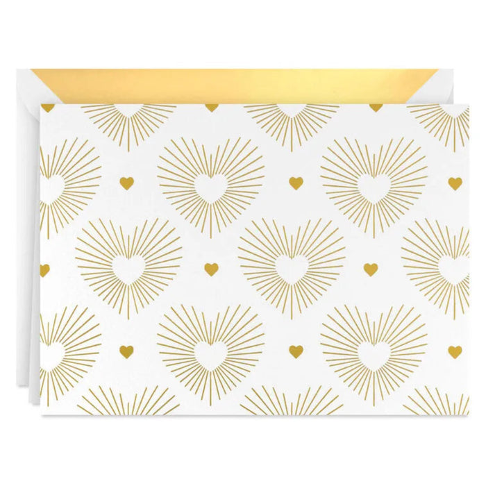 Card with gold heart and sunburst pattern on a white background