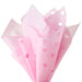 Close‑up of pink tissue paper showing striped pattern and heart‑cutout design