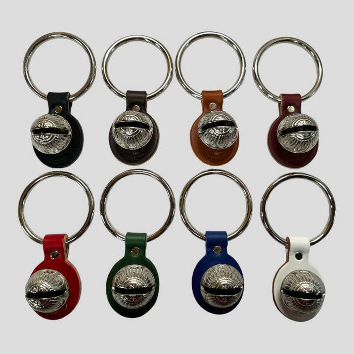 Set of keychains with metal bells on a white background