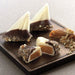 Sailboat shaped almond buttercrunch toffee covered with white chocolate and dipped in dark chocolate and pecan spindrift
