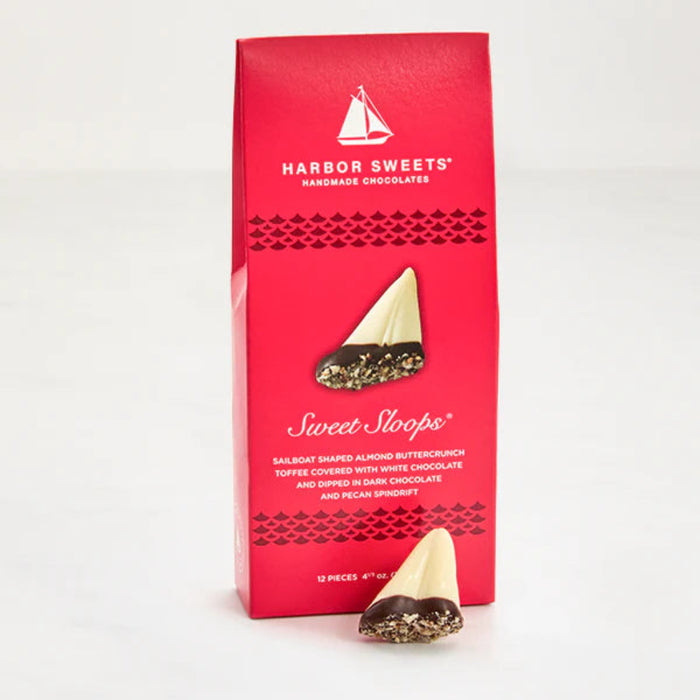 Sailboat shaped almond buttercrunch toffee covered with white chocolate and dipped in dark chocolate and pecan spindrift