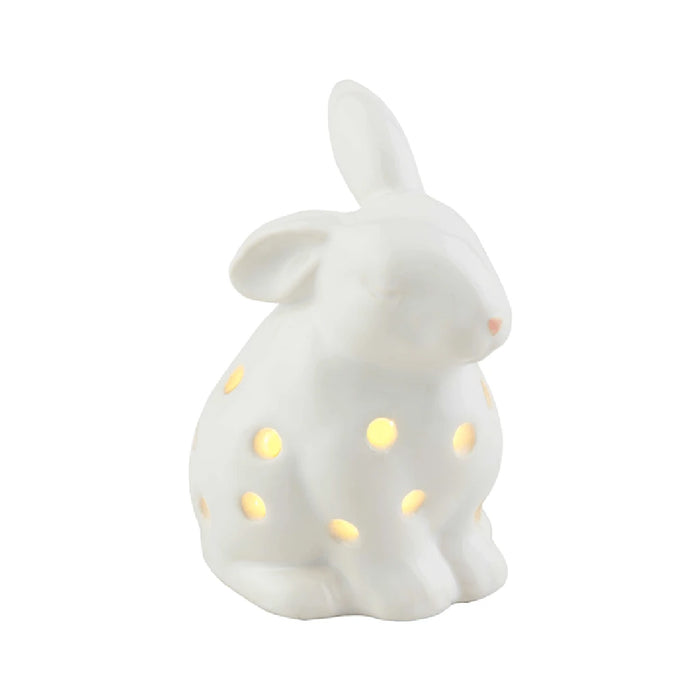 A white ceramic bunny adorned with colorful polka dots, sitting upright with a cheerful expression.
