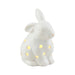 A white ceramic bunny adorned with colorful polka dots, sitting upright with a cheerful expression.