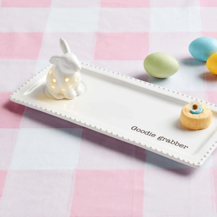 A whimsical white ceramic bunny embellished with colorful polka dots, ideal for seasonal decoration.