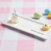 A whimsical white ceramic bunny embellished with colorful polka dots, ideal for seasonal decoration.