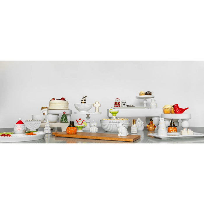 A cute white ceramic bunny with a playful polka dot design, enhancing the charm of any decorative arrangement.