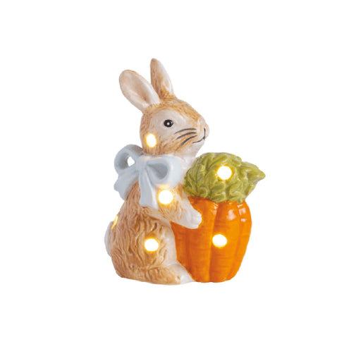 A decorative rabbit figurine holding a small pumpkin, showcasing a whimsical autumn theme