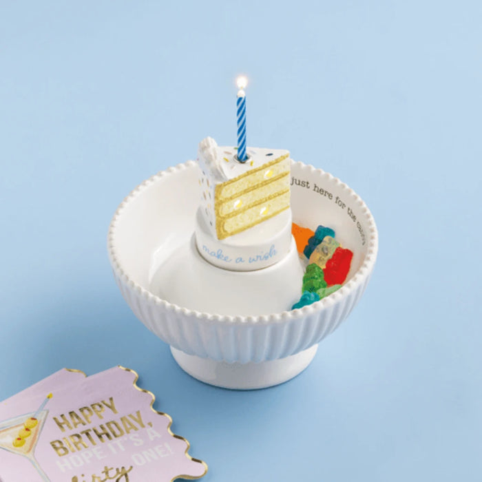A vibrant candle positioned on a piece of cake, highlighting a celebratory moment.