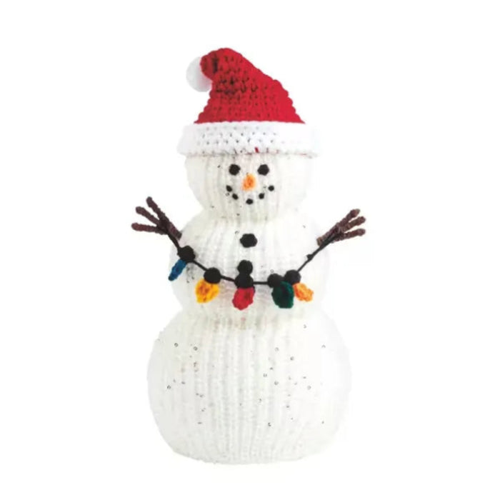Mud Pie large white crochet snowman sitter with a red Santa hat, twig arms, and colorful light garland.