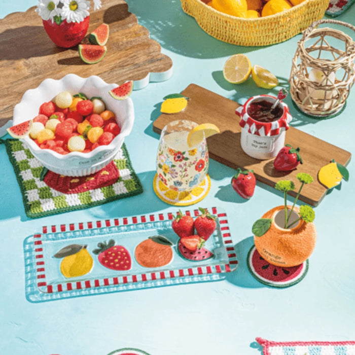 A pair of salt and pepper shakers designed as watermelons, featuring bright colors and a whimsical design for table decor.