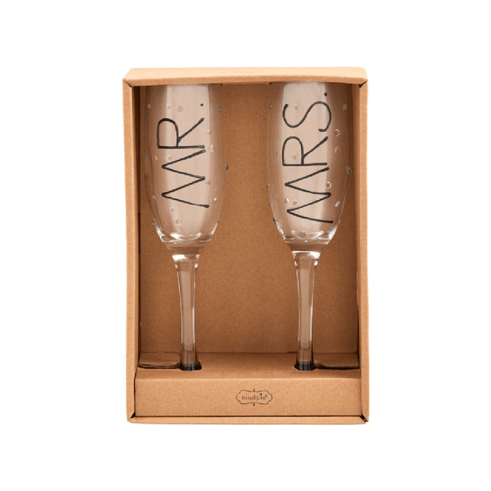 Two champagne flutes labeled "Mrs" and "Ws," elegantly arranged for a celebration.