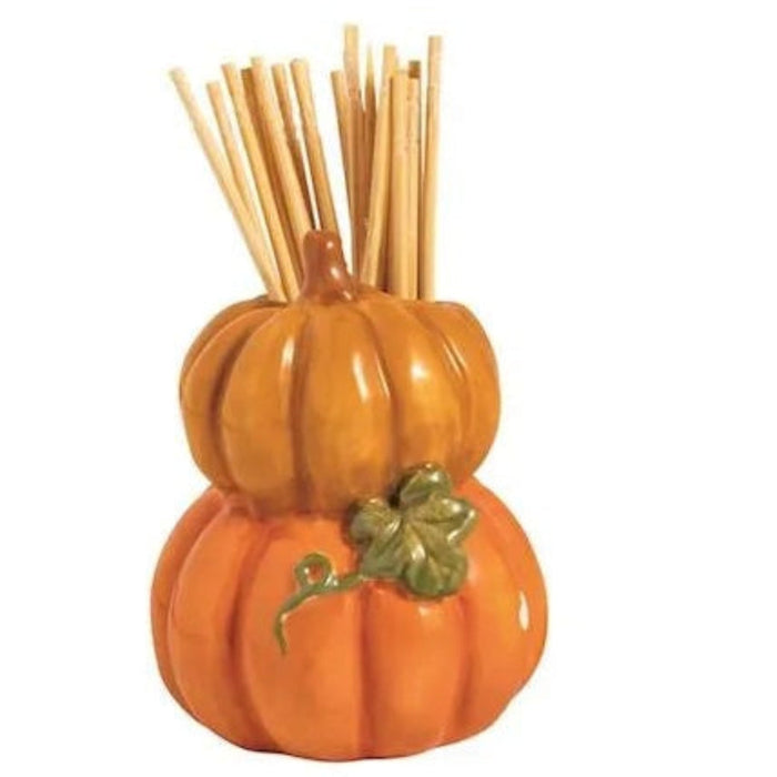 Two decorative items shaped like a pumpkin and a cake with wooden sticks on a white background.