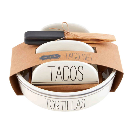 A taco set featuring fresh tortillas and a wooden spoon for serving.