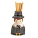 Ceramic figure of a pilgrim with a hat holding wooden sticks on a white background