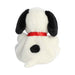 A cuddly stuffed dog with a red collar, sitting on a white surface, radiating warmth and playfulness.