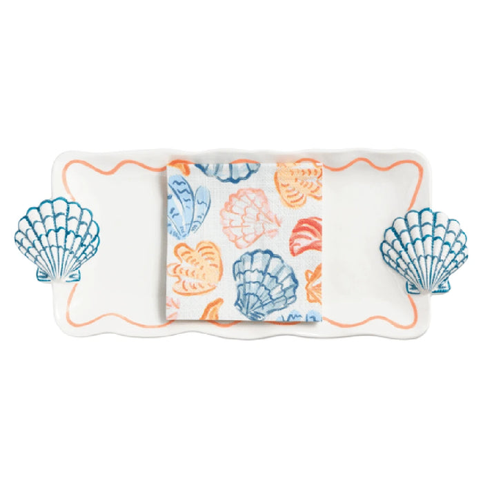 A white tray displaying an assortment of blue and orange shells arranged neatly on its surface.