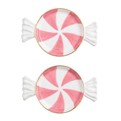 Two pink and white peppermint candy-shaped cookies on a white background