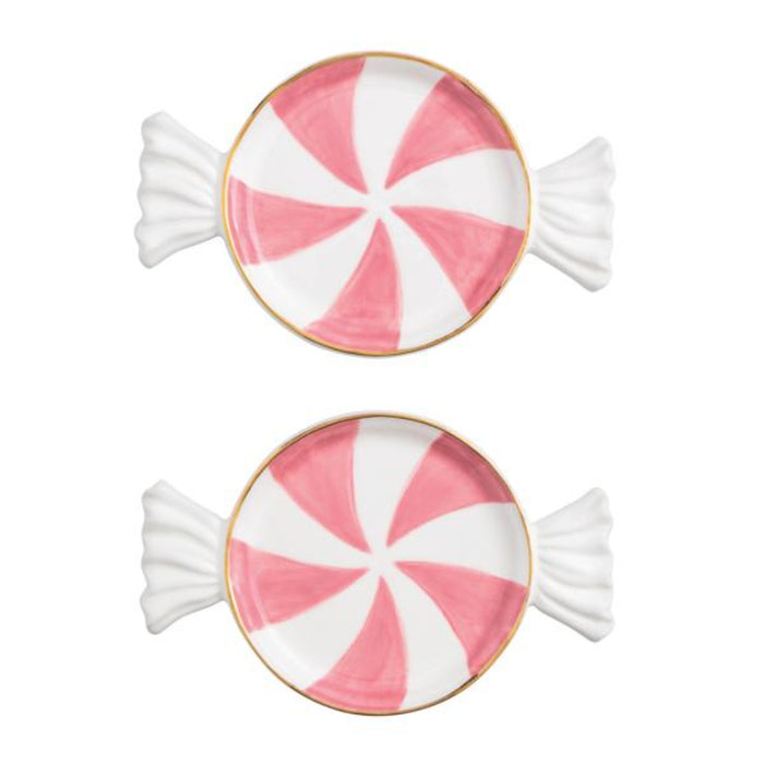 Two pink and white peppermint candy-shaped cookies on a white background