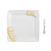 A square plate holds an assortment of crackers and slices of cheese arranged neatly.