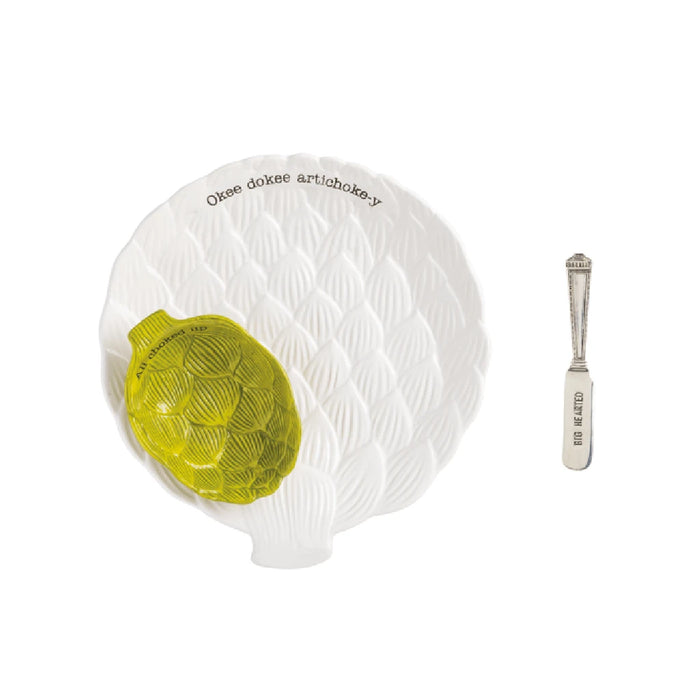 A white plate featuring a single green artichoke centered on it.