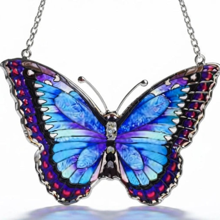 Bridgeton Hall Morpho Butterfly stained-glass-style suncatcher measuring 5.75 by 4.25 inches, featuring vibrant blue butterfly wings hanging in a sunny window.