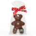 Chocolate bear in a clear bag with a red polka dot bow on a white background