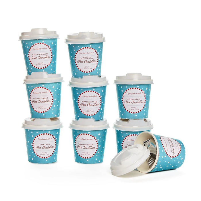 Set of 9 blue polka dot hot chocolate cups with white lids on a white background