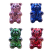 Four colorful glittery bear-shaped objects on a white background