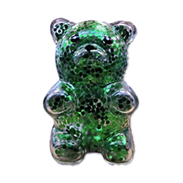 Green glittery bear-shaped object on a white background