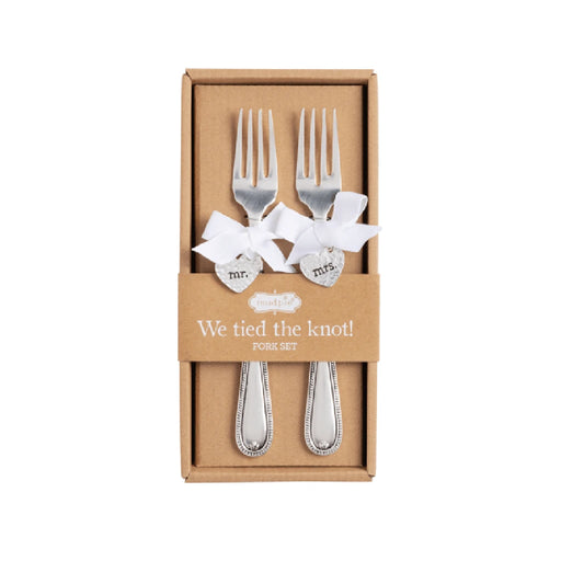 A beautifully arranged wedding gift set labeled "We Fed the Lord," featuring elegant tableware and decorative items.