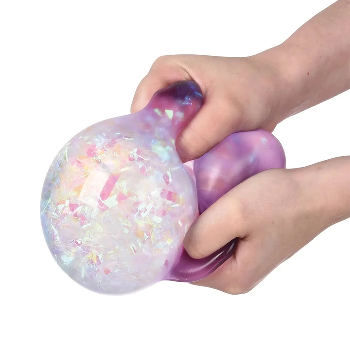 Hand holding a colorful, iridescent stress ball against a white background