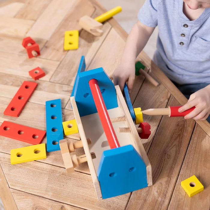 A wooden tool box displaying an array of tools and playful toys, highlighting a combination of craftsmanship and fun.