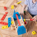 A wooden tool box displaying an array of tools and playful toys, highlighting a combination of craftsmanship and fun.