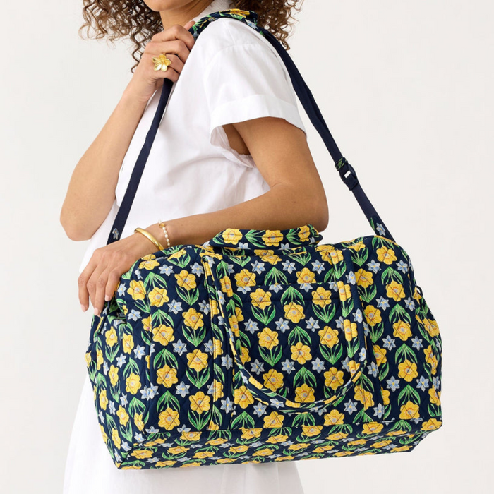 Person holding Vera Bradley Miramar Weekender in Daffodils – quilted cotton floral weekender bag with spacious interior and zipper closure