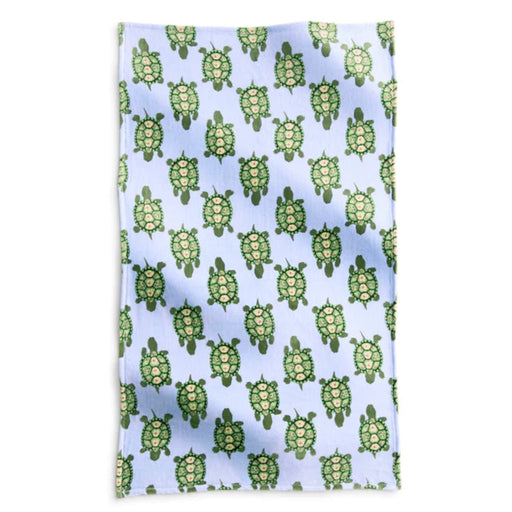 A towel featuring a vibrant blue and green turtle pattern, ideal for beach or pool use.