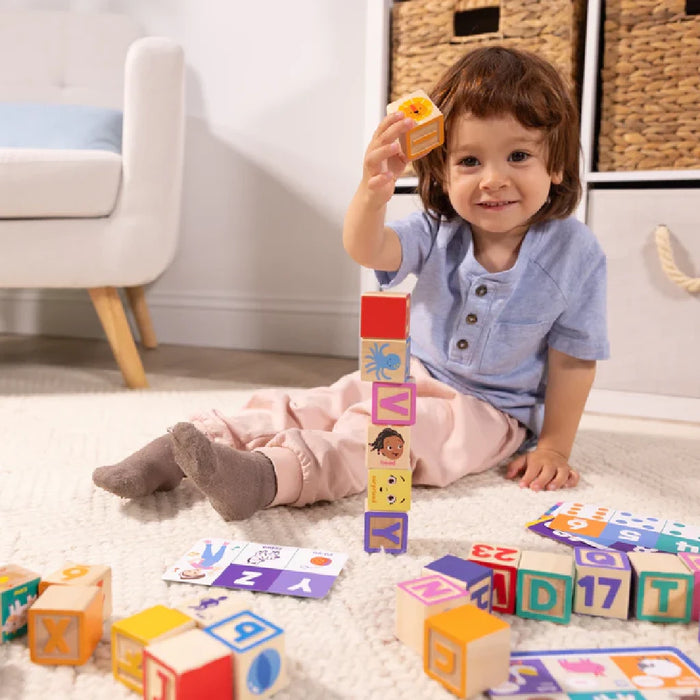 A wooden block illustrating the complete alphabet from A to Y, including both uppercase and lowercase letters.