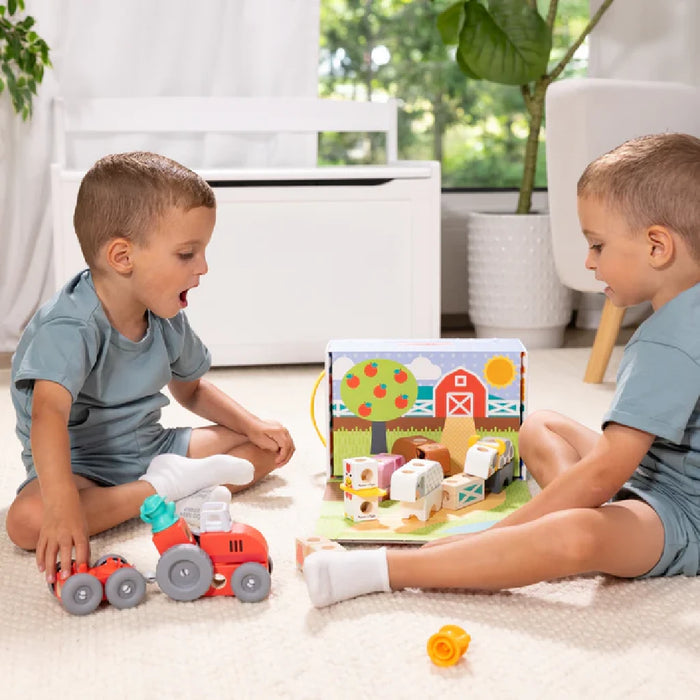 A charming wooden toy set with detailed farm animals, including a barn, cows, and pigs, designed for creative play.