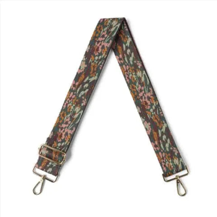 Floral patterned strap with metal clasps on a white background
