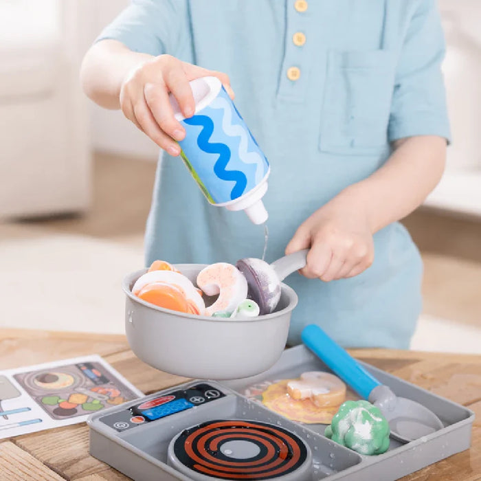 A food tray featuring various dishes and accompanying utensils arranged neatly.