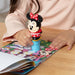 A sticker book adorned with Minnie Mouse designs and a toy, appealing to children and collectors alike.