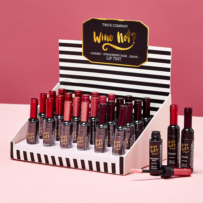 Display of 'Wine Not?' lip tint bottles with a striped box on a pink - background. Assorted chosen at random 